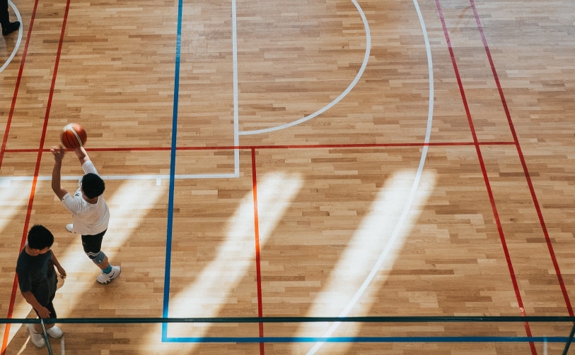 two people playing on basketball court